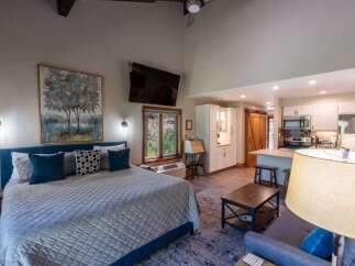 Experience modern comfort in this studio apartment featuring a plush king-sized bed and a fully equipped kitchenette perfect for preparing meals.
