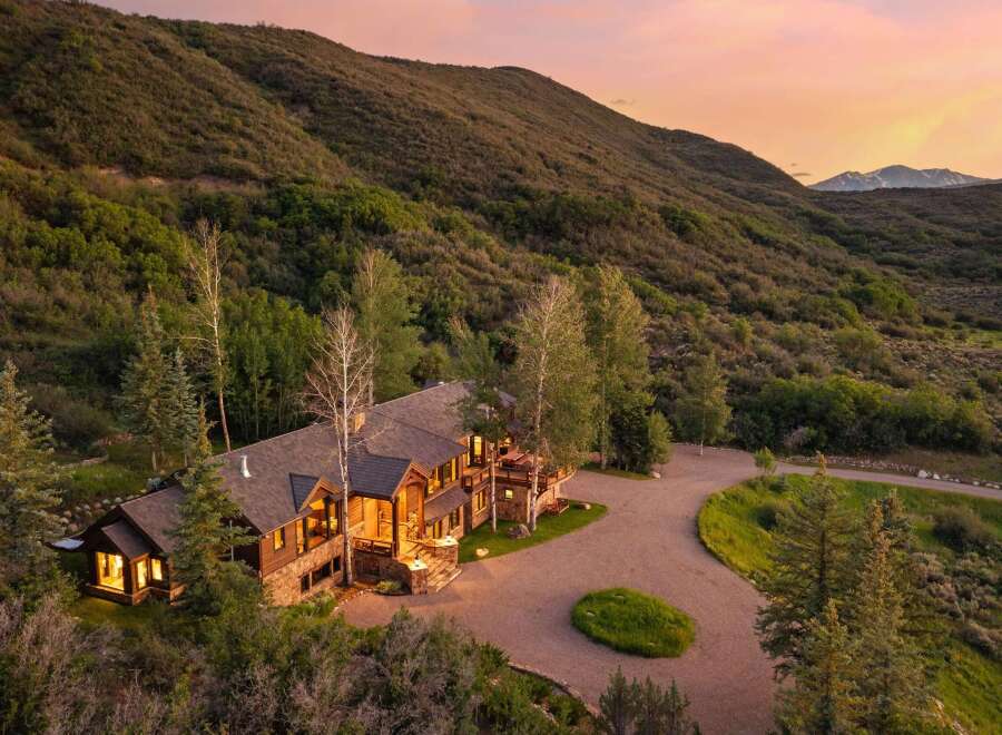 Nestled amidst rolling hills and mature trees, this stunning mountain lodge offers unparalleled privacy and breathtaking views.