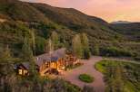 Nestled amidst rolling hills and mature trees, this stunning mountain lodge offers unparalleled privacy and breathtaking views.