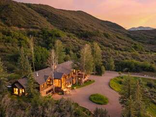 Nestled amidst rolling hills and mature trees, this stunning mountain lodge offers unparalleled privacy and breathtaking views.