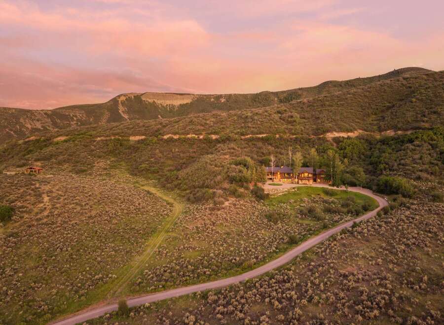 Experience luxury living in this stunning mountain estate, nestled amidst rolling hills and breathtaking sunset views.
