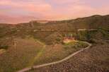 Experience luxury living in this stunning mountain estate, nestled amidst rolling hills and breathtaking sunset views.