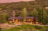 Experience luxury mountain living in this stunning custom-built home, nestled against a picturesque hillside.