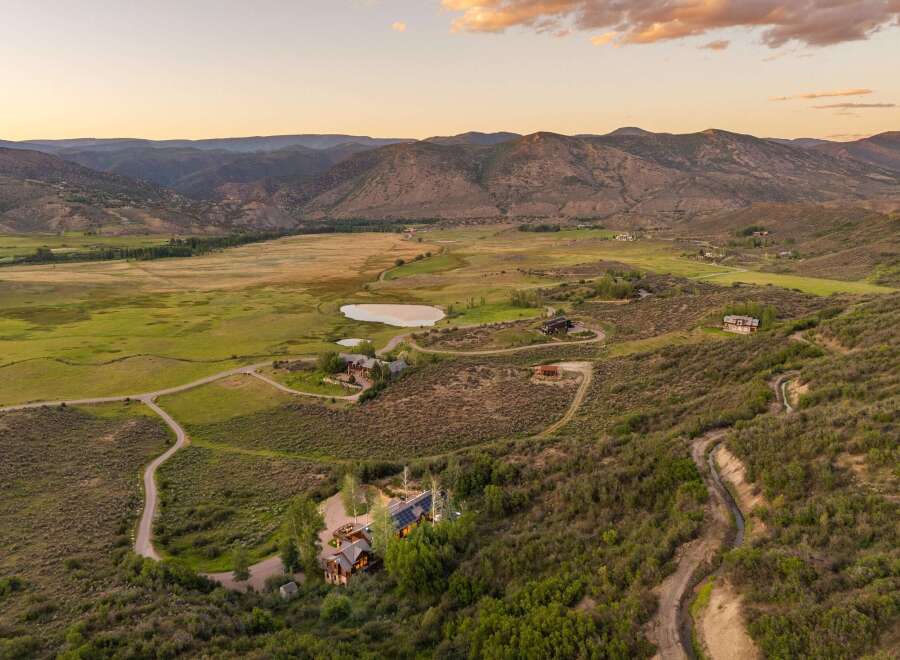 Experience breathtaking mountain vistas from this expansive estate, featuring a main residence with solar panels and a charming guest house.