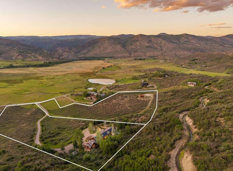 Discover this expansive property nestled in a serene mountain valley, offering breathtaking panoramic views.