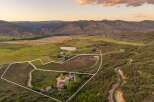 Discover this expansive property nestled in a serene mountain valley, offering breathtaking panoramic views.