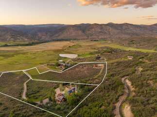 Discover this expansive property nestled in a serene mountain valley, offering breathtaking panoramic views.