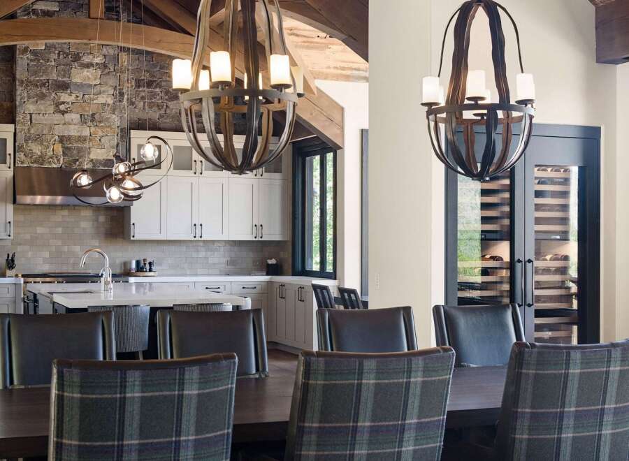 Experience luxury living in this stunning home featuring a gourmet kitchen with a stone accent wall and sleek cabinetry.