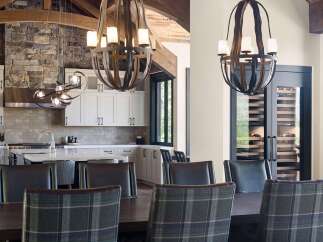Experience luxury living in this stunning home featuring a gourmet kitchen with a stone accent wall and sleek cabinetry.