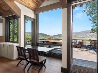 Experience breathtaking mountain views from this stunning home, featuring a spacious deck perfect for outdoor entertaining.