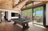 Experience ultimate relaxation and entertainment in this stunning game room, featuring a professional-grade pool table and a large flat-screen TV.