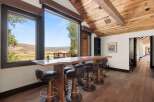 Experience breathtaking mountain views from this stunning live-edge bar, perfect for entertaining guests.