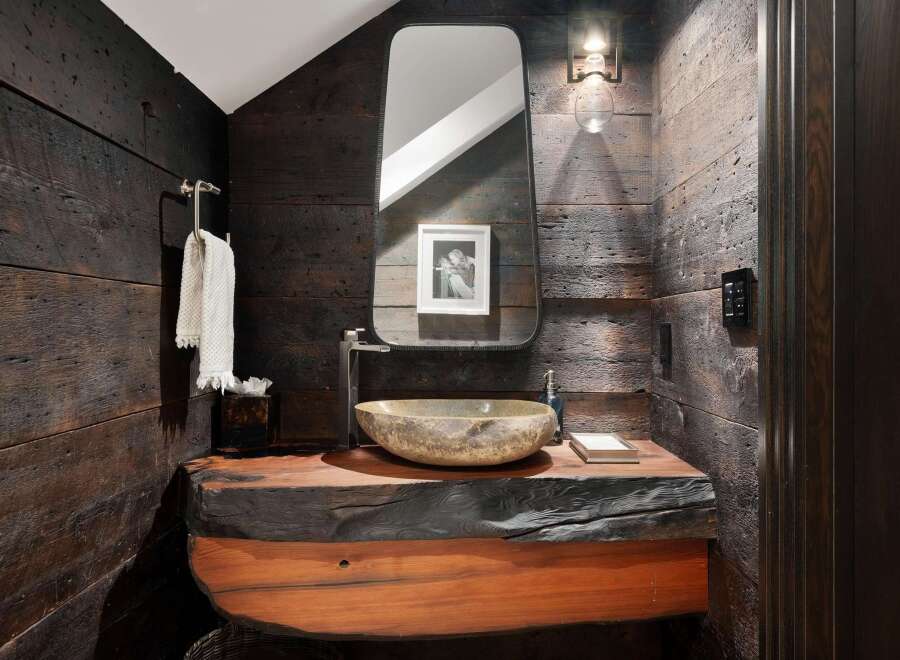 Experience rustic elegance in this powder room, featuring a live-edge wood vanity that adds a unique, natural touch.