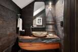Experience rustic elegance in this powder room, featuring a live-edge wood vanity that adds a unique, natural touch.