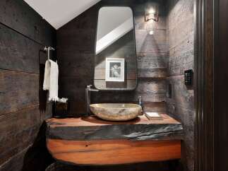 Experience rustic elegance in this powder room, featuring a live-edge wood vanity that adds a unique, natural touch.