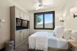 Experience serene mountain living in this charming bedroom, featuring a built-in entertainment center and a large window with breathtaking views.