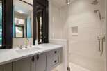 Experience modern luxury in this stunning bathroom featuring a sleek vanity with a undermount sink and brushed nickel fixtures.