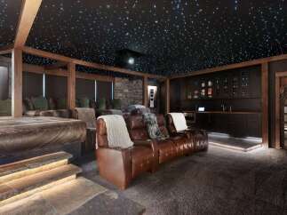 Experience ultimate relaxation in this luxurious home theater, complete with plush leather recliners and a stunning starry night ceiling.