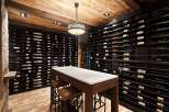 Discover this exquisite wine cellar, featuring extensive wine racks capable of holding a vast collection.
