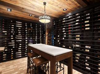 Discover this exquisite wine cellar, featuring extensive wine racks capable of holding a vast collection.