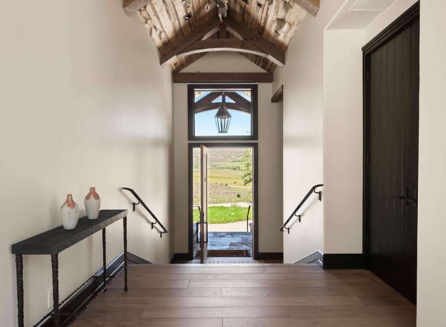 Step into this stunning entryway featuring a vaulted wood-beamed ceiling and a grand lantern.