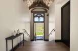 Step into this stunning entryway featuring a vaulted wood-beamed ceiling and a grand lantern.
