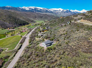 Nestled in a picturesque mountain valley, this stunning property offers breathtaking panoramic views of snow-capped peaks.
