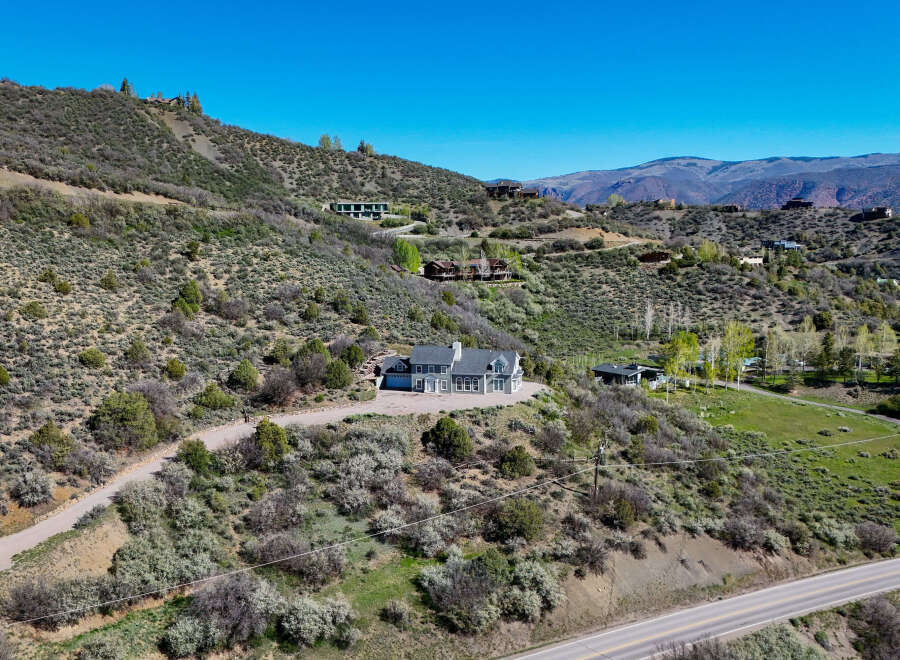 Nestled on a scenic hillside, this property offers a stunning retreat with multiple residences and breathtaking mountain views.