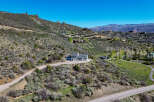 Nestled on a scenic hillside, this property offers a stunning retreat with multiple residences and breathtaking mountain views.