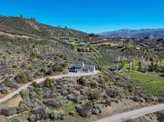 Nestled on a scenic hillside, this property offers a stunning retreat with multiple residences and breathtaking mountain views.