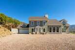 Discover this stunning home featuring a welcoming facade with a prominent entrance and a spacious two-car garage.