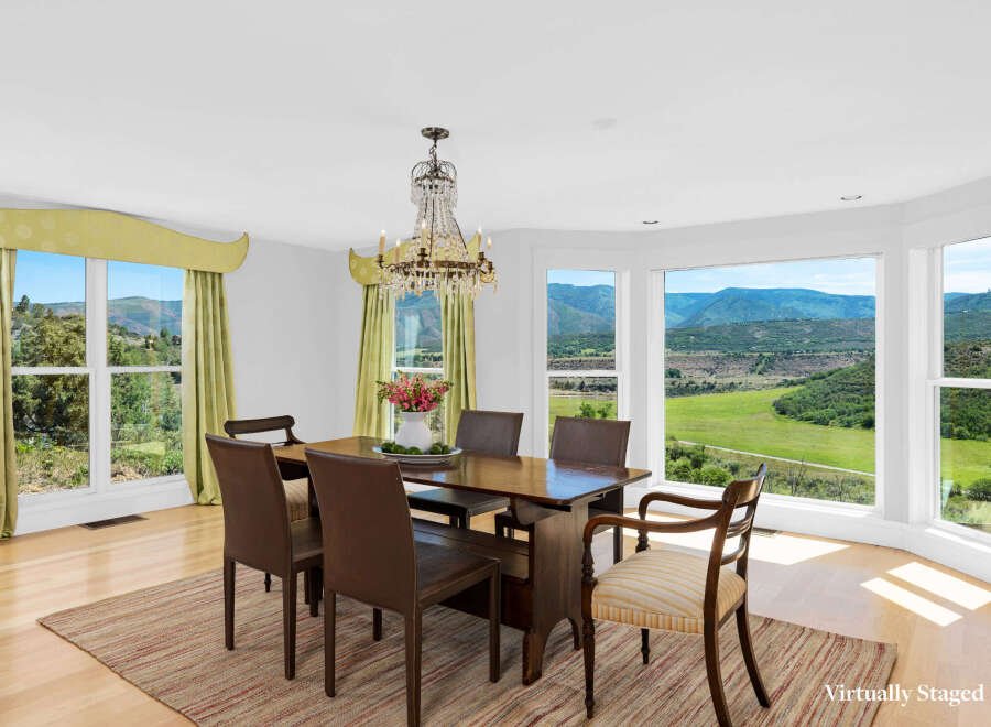 Experience breathtaking mountain views from this elegant dining room, perfect for hosting memorable gatherings.