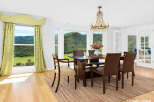 Experience breathtaking mountain views from this elegant dining room, featuring a stunning crystal chandelier and large windows that flood the space with natural light.