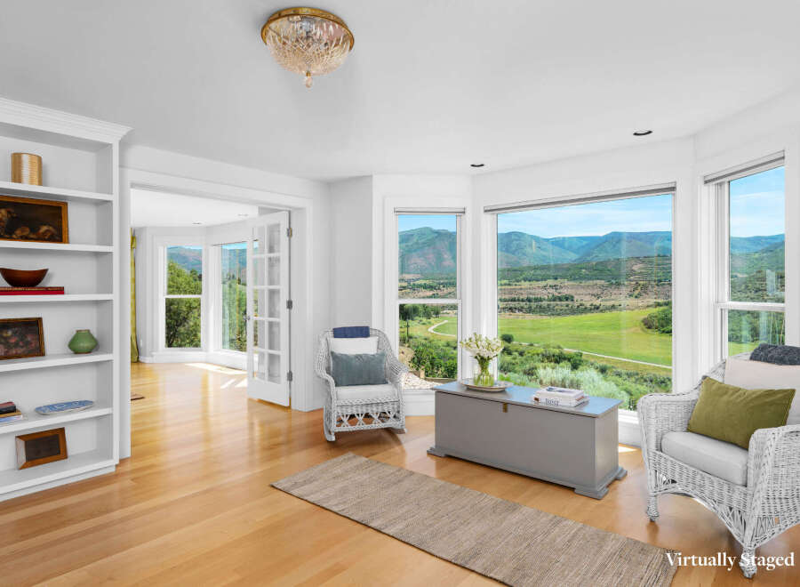 Experience breathtaking mountain views from this stunning living area, featuring expansive windows that flood the space with natural light.