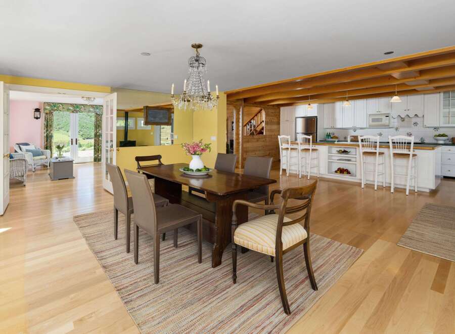 Experience open-concept living with this charming dining area and adjacent kitchen.