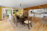 Experience open-concept living with this charming dining area and adjacent kitchen.