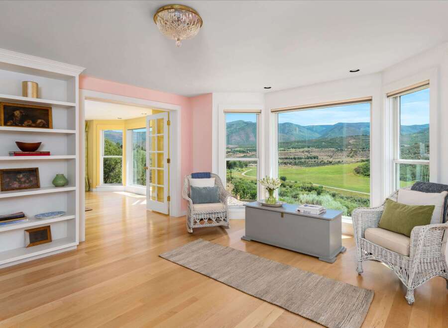 Experience breathtaking mountain views from this stunning living room, featuring a large bay window that floods the space with natural light.