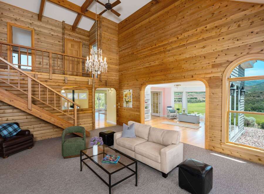 Experience rustic charm and breathtaking views in this stunning log cabin-style living room.