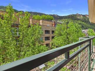 Enjoy breathtaking mountain views from this stunning property, featuring modern architecture and lush greenery.