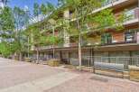 Discover modern living in this vibrant urban setting, featuring a multi-story building with balconies and large windows.