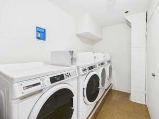 Discover the convenience of this on-site laundry facility, featuring multiple Maytag high-efficiency washers.