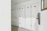 Discover convenient storage solutions with this row of white doors, each labeled with a unit number for easy identification.