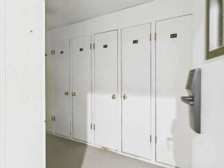 Discover convenient storage solutions with this row of white doors, each labeled with a unit number for easy identification.