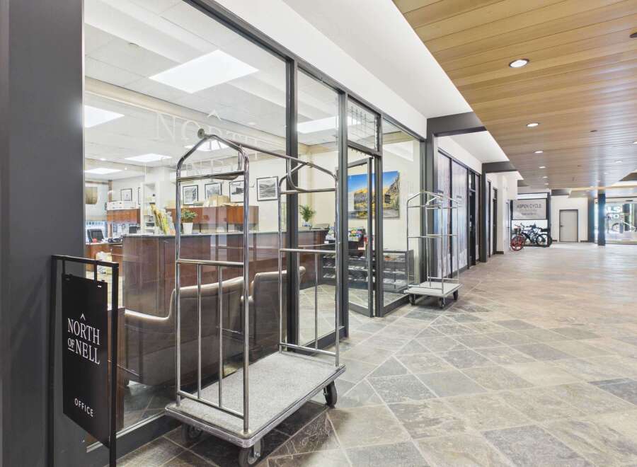Experience the welcoming ambiance of this property's lobby, featuring a modern design with elegant wood accents and a spacious, well-lit interior.