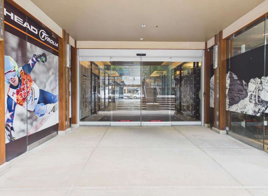 Discover a prime commercial space featuring a modern storefront with automatic glass doors, perfect for attracting customers.