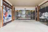 Discover a prime commercial space featuring a modern storefront with automatic glass doors, perfect for attracting customers.
