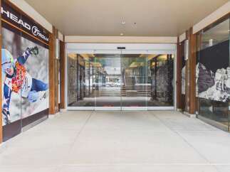 Discover a prime commercial space featuring a modern storefront with automatic glass doors, perfect for attracting customers.
