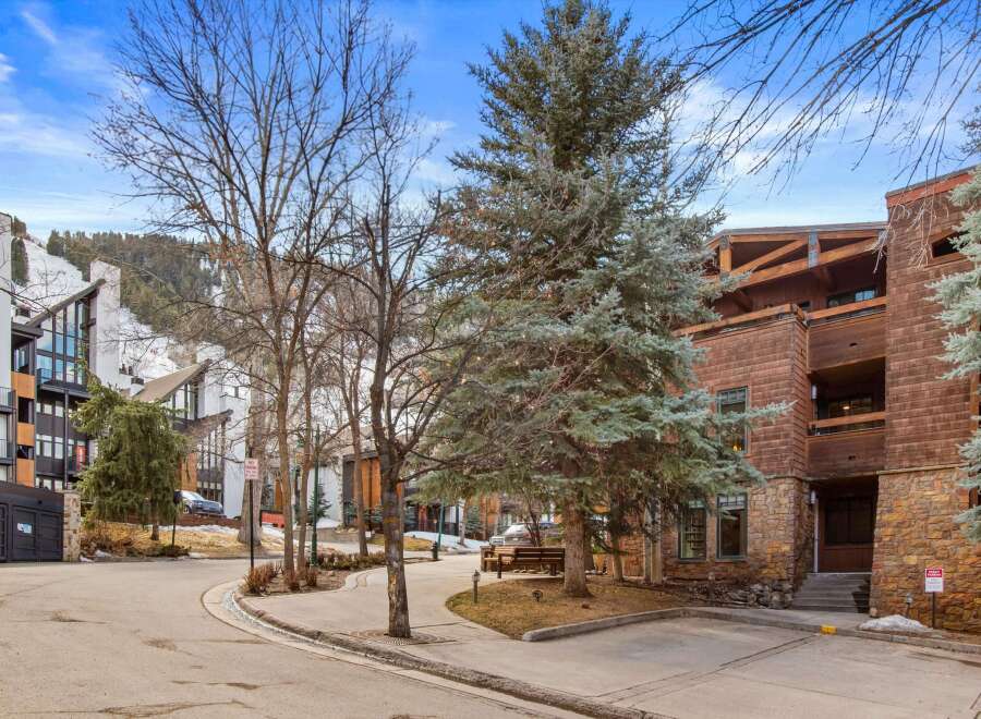 Discover this stunning mountain property featuring modern architecture with a blend of stone and wood accents.