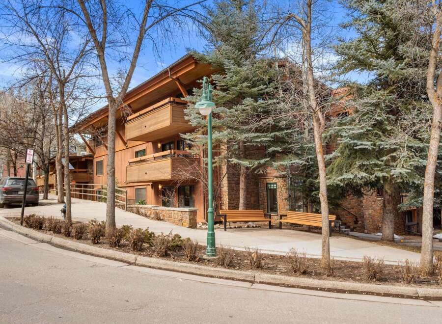 Experience luxury mountain living in this stunning property featuring a striking timber-framed exterior and expansive balconies perfect for enjoying the crisp alpine air.