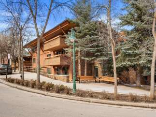 Experience luxury mountain living in this stunning property featuring a striking timber-framed exterior and expansive balconies perfect for enjoying the crisp alpine air.